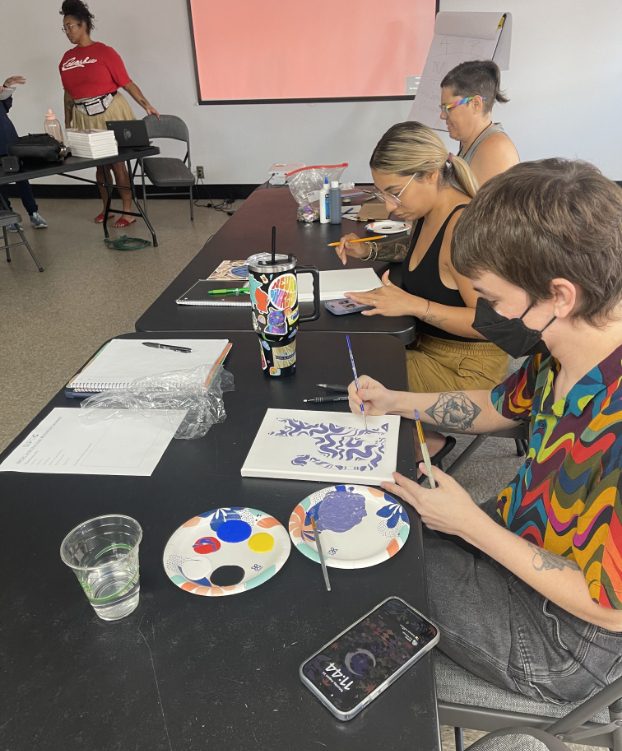 Bipoc artists painting some artwork